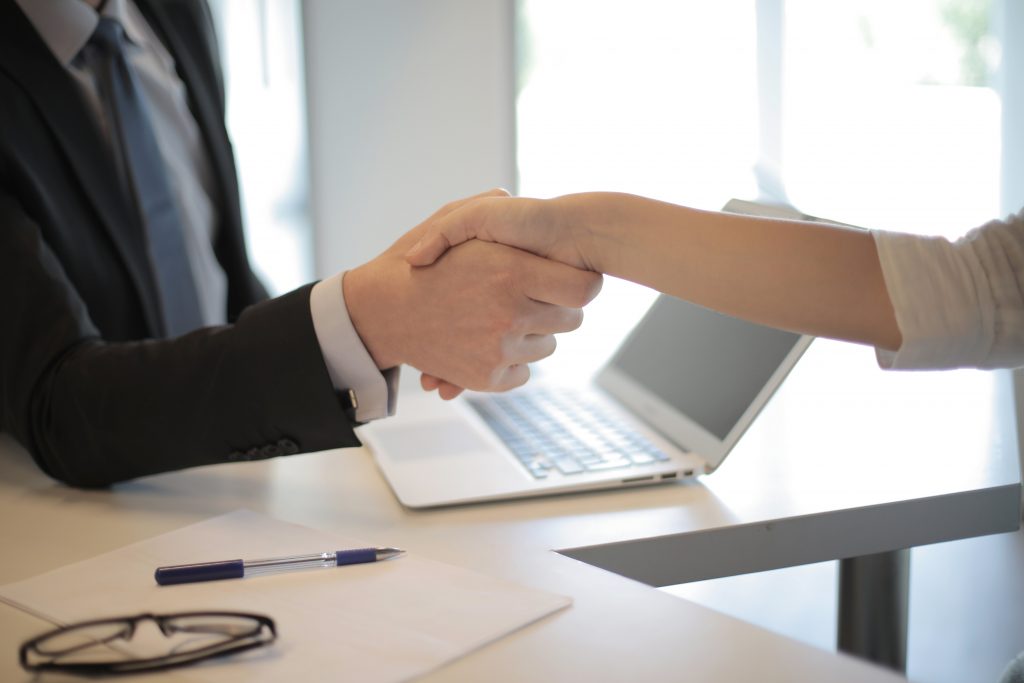 shaking hands hiring staff hr and payroll