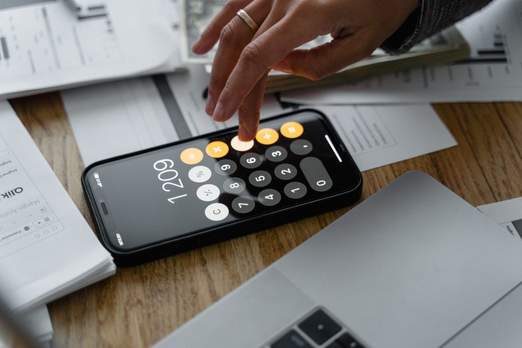 person using calculator payroll employer of record